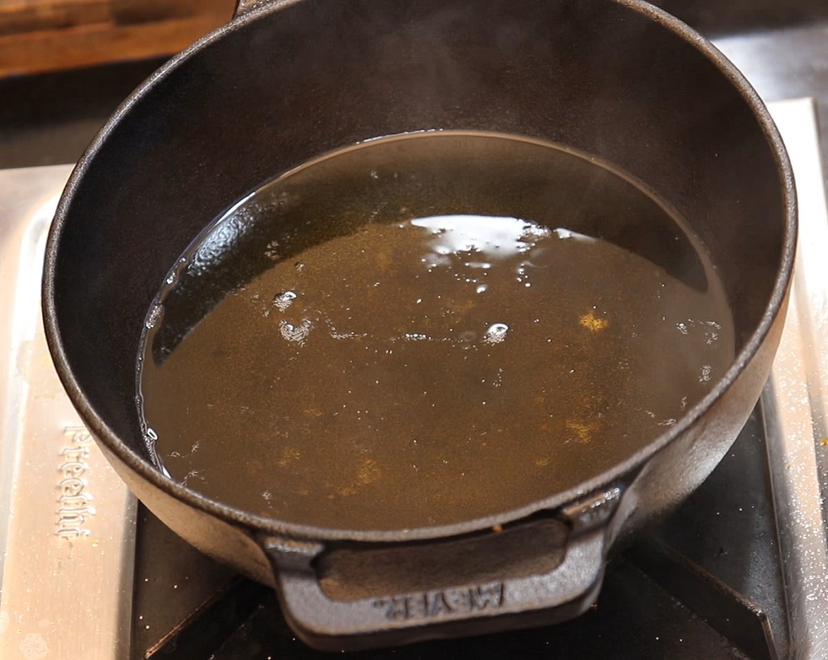 Heat oil in a frying pan to fry medu vada